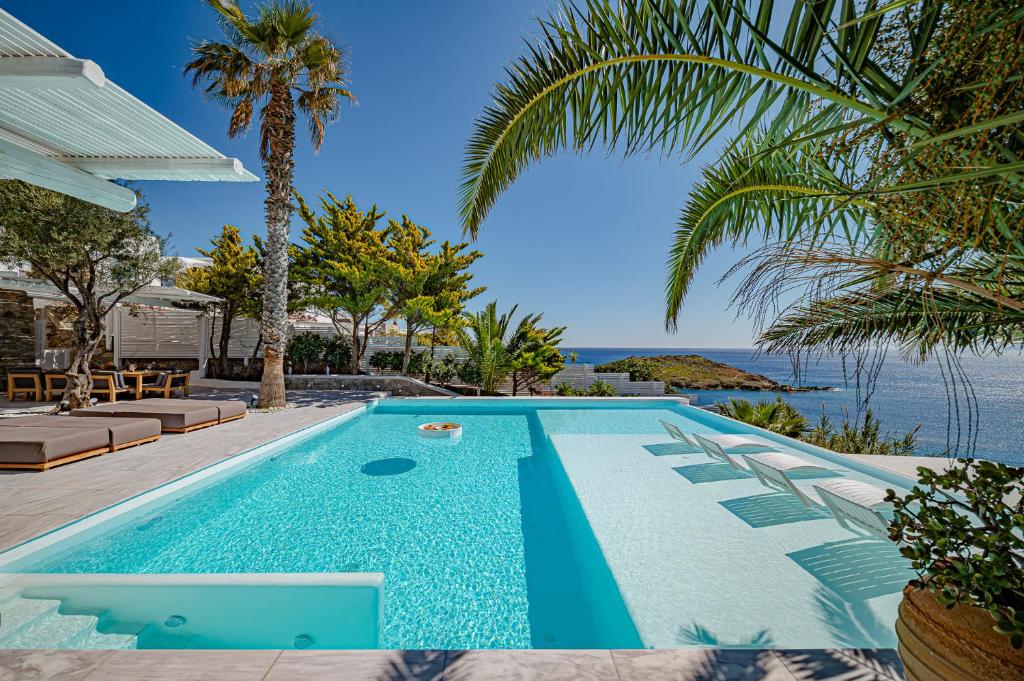 a swimming pool with a view of the ocean at Sanarte Villas Mykonos in Mýkonos City