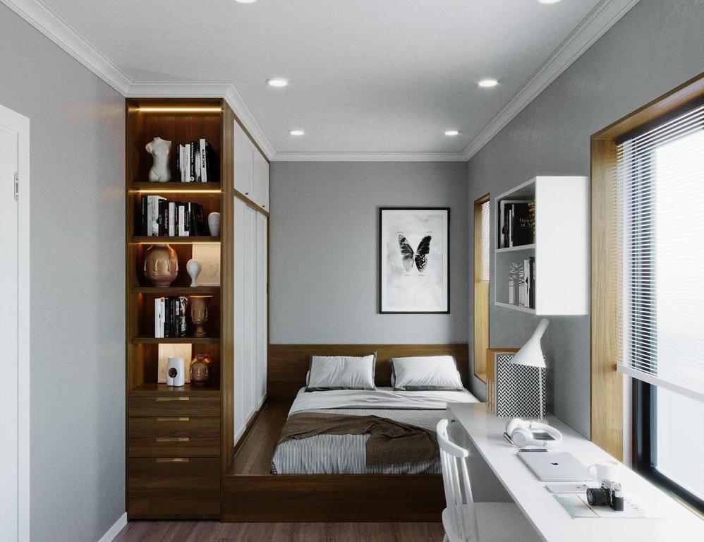a bedroom with a bed and a desk at The Manor Crown T12 in Thôn Trường Giang
