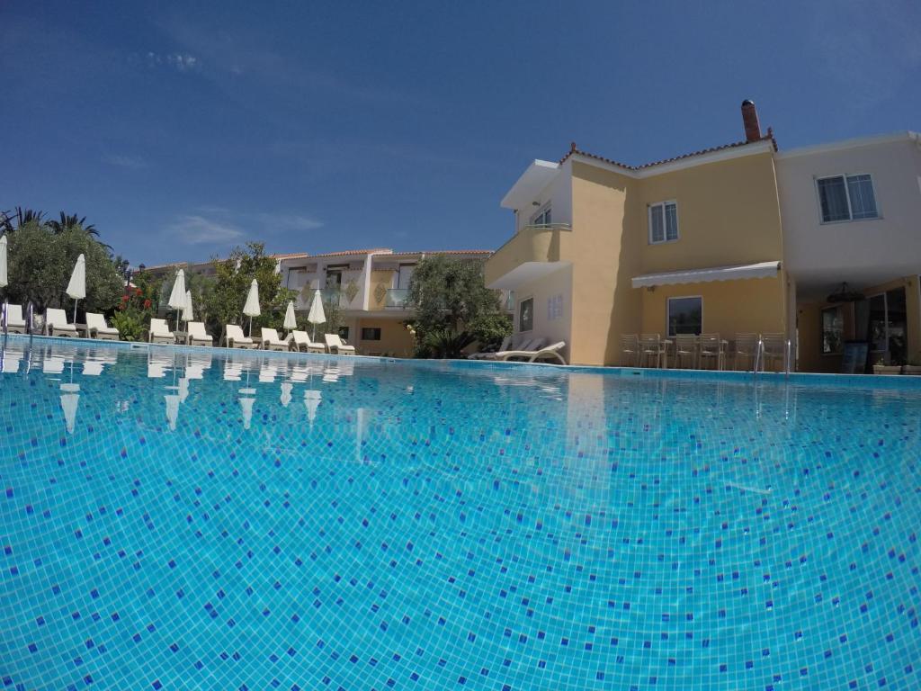a large swimming pool in front of a building at Aparthotel Sunset in Petra