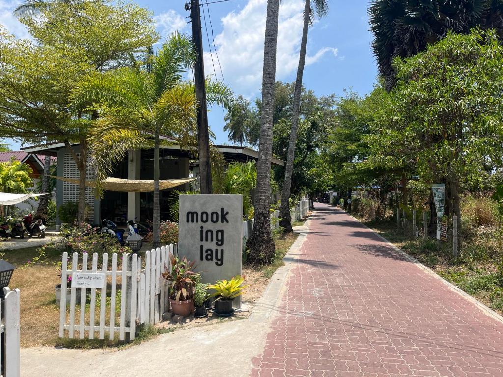 a brick road with a sign that reads mock king lay at Mook Ing Lay in Ko Mook