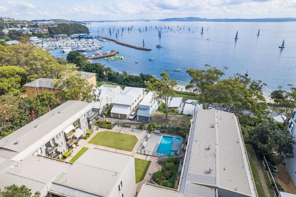 an aerial view of a house with a body of water at The Poplars, 6,36 Magnus Street - Unit with fabulous views and a complex pool in Nelson Bay