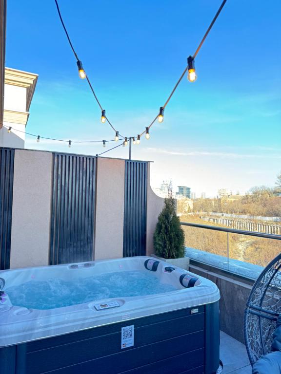 a hot tub on a balcony with a view at Luxury apartment with jacuzzi Pechersk Plaza in Kyiv