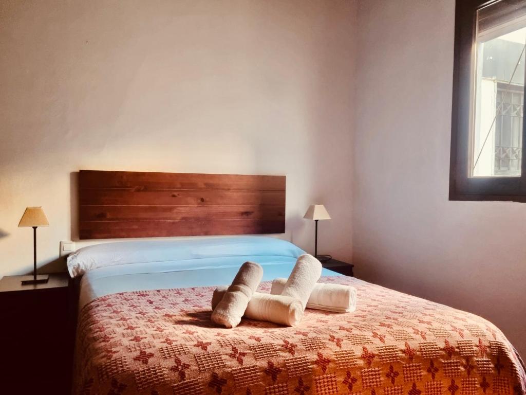 a bedroom with a bed with two towels on it at Central, near the Alhambra, quiet and autentic! in Granada