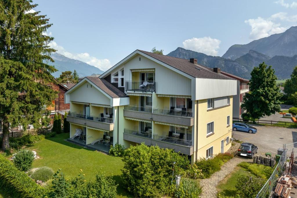 an aerial view of a building with mountains in the background at Casa Viva Bad Ragaz in Bad Ragaz