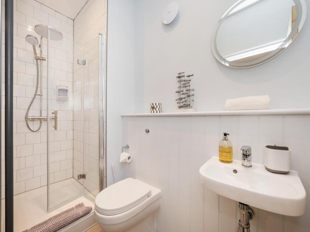 a bathroom with a toilet and a sink and a shower at The Sands Sheringham in Sheringham