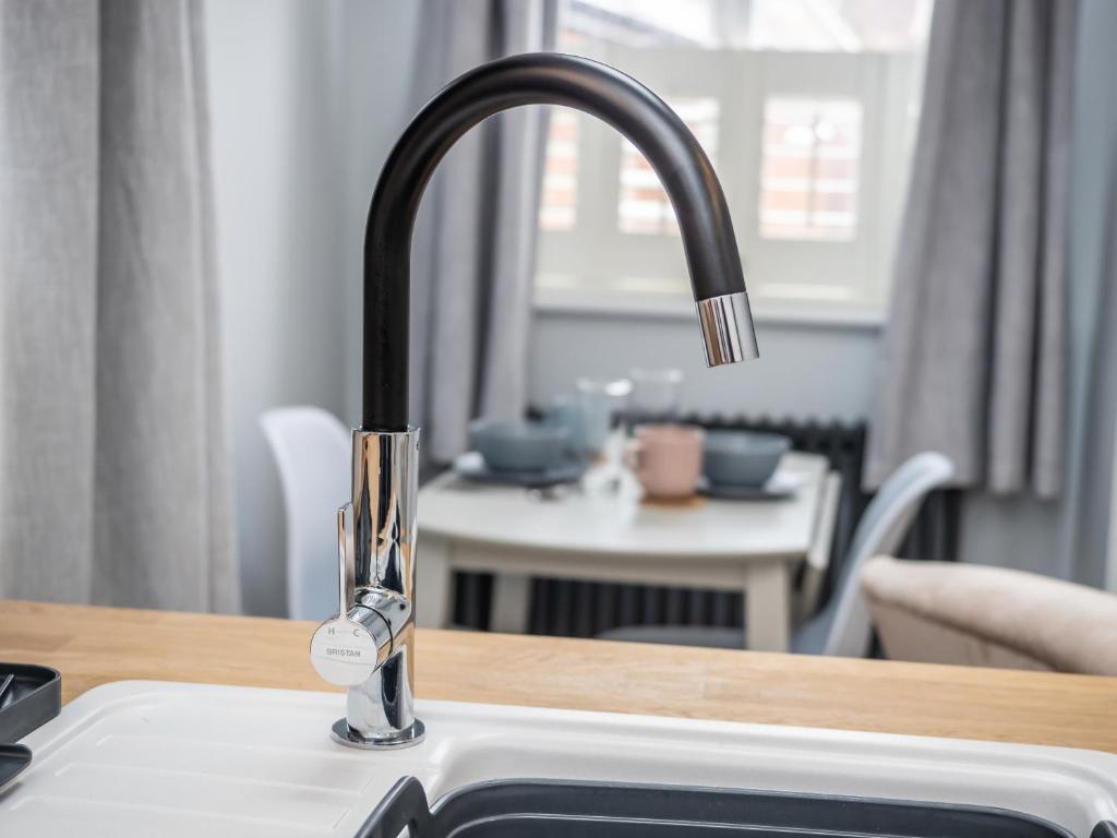 a kitchen sink with a faucet on a counter at The Sands Sheringham in Sheringham