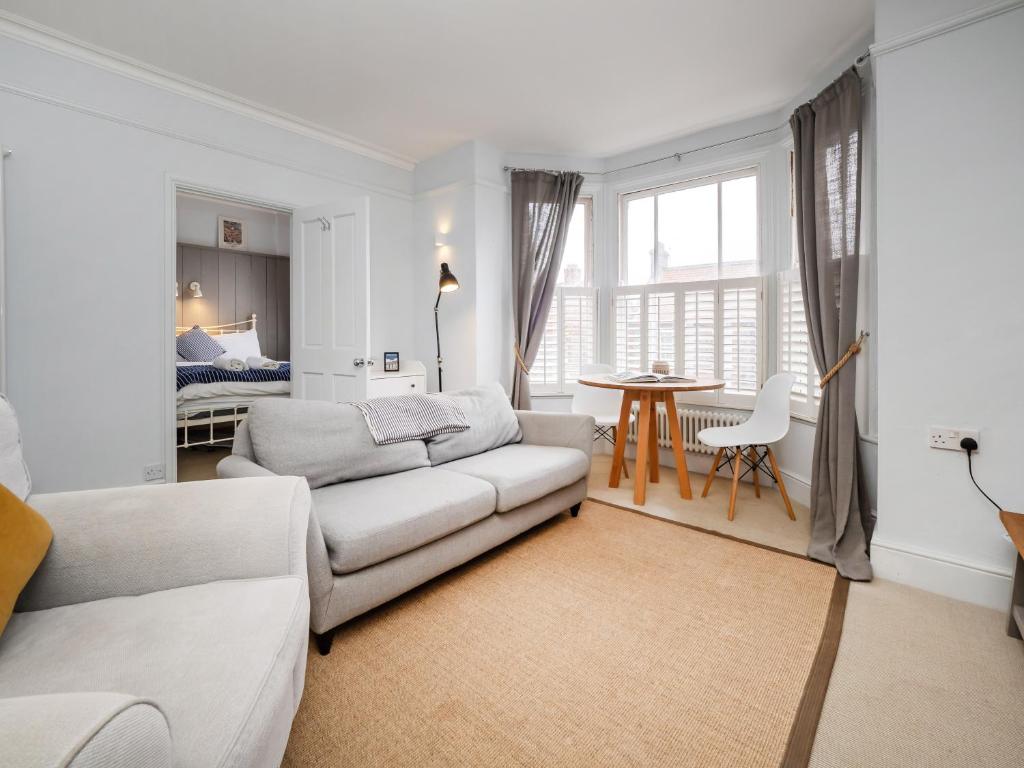 a living room with a couch and a table at The Sands Sheringham in Sheringham