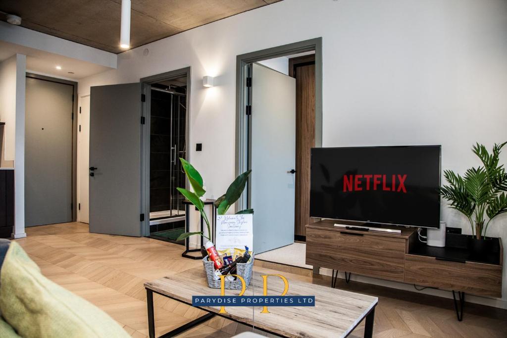 a living room with a tv and a coffee table at The Executive Suite - By Parydise Properties - Business or Leisure stays - Sleeps 2 - Deansgate, Manchester in Manchester