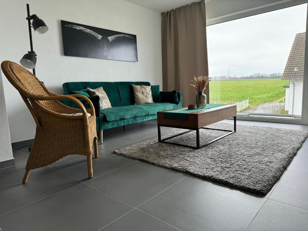 sala de estar con sofá verde y mesa de centro en Modern & großzügig! Ideal für Familie & Arbeit en Linden