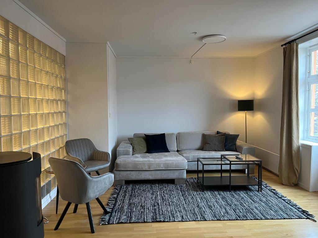 a living room with a couch and a chair at Dokkeveien Apartment in Bergen