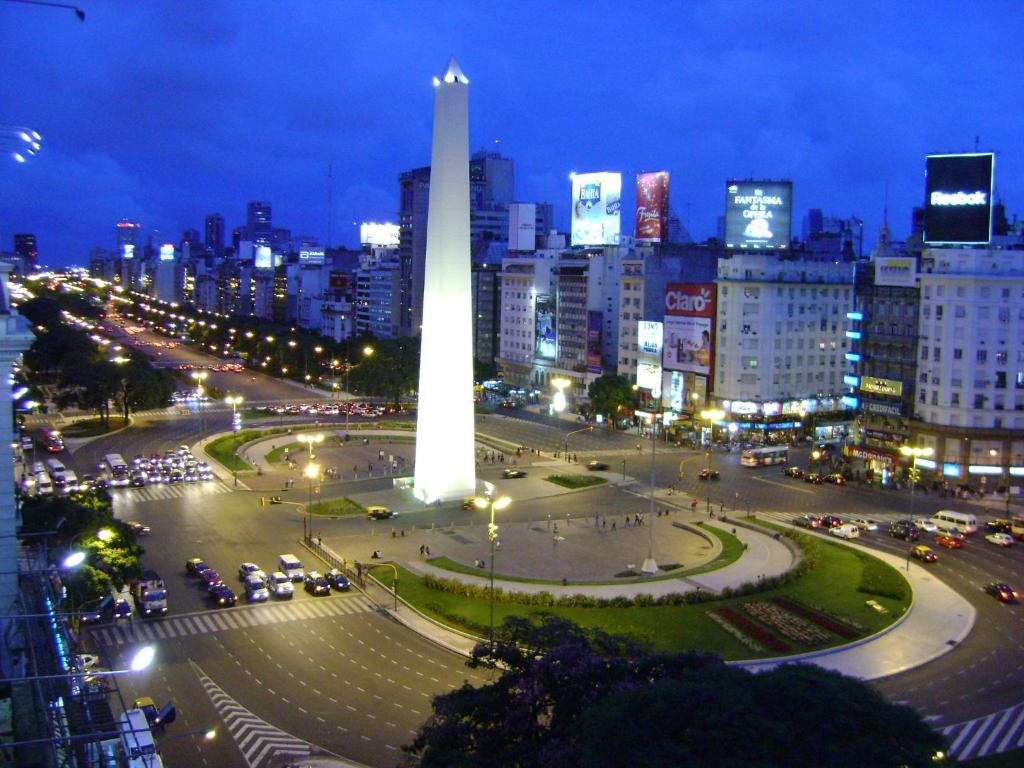 a large white obelisk in a city at night at Bristol Hotel in Buenos Aires