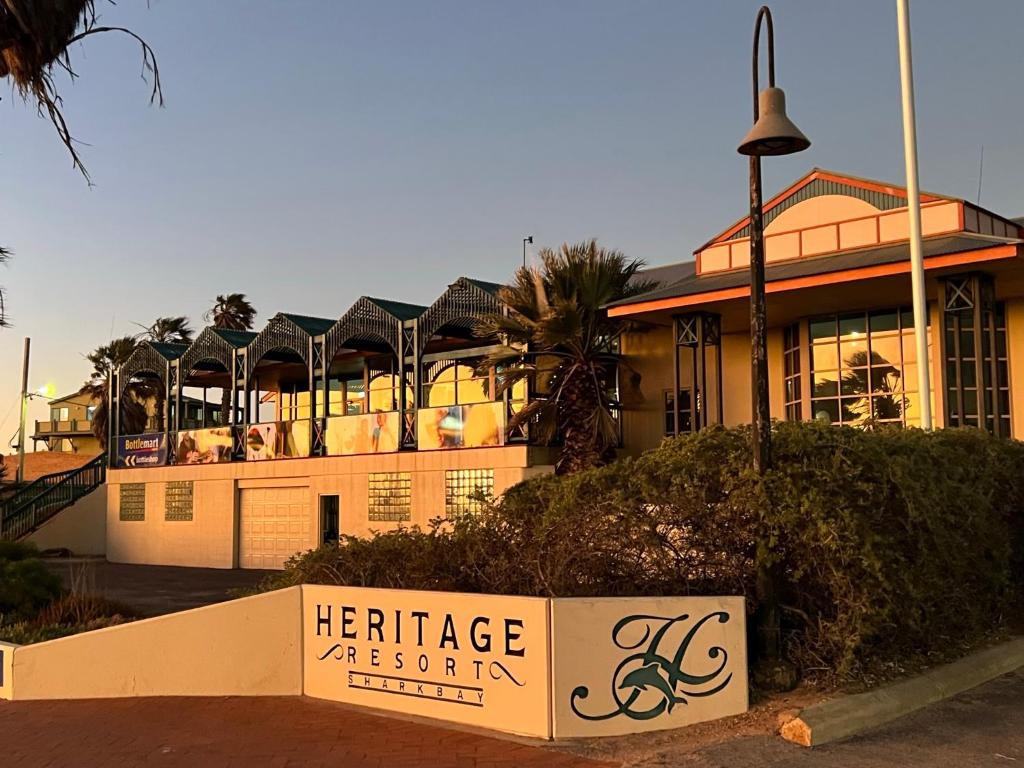 a large building with a sign in front of it at Heritage Resort Shark Bay in Denham