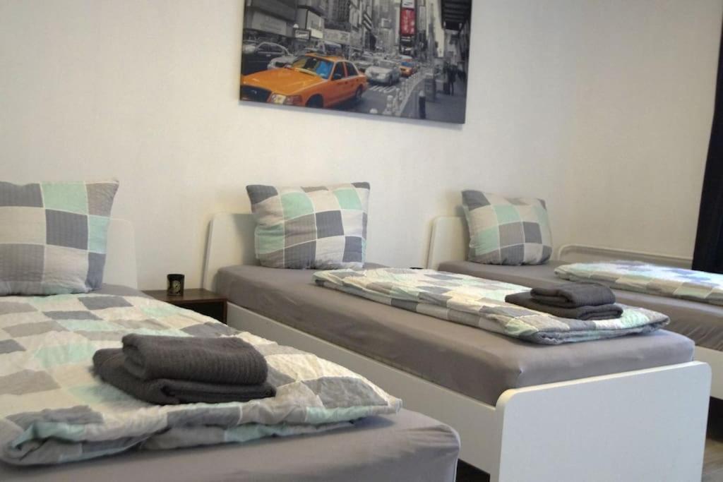 two beds in a room with a car on the wall at Maye Oberhausen City Deluxe 3 in Oberhausen