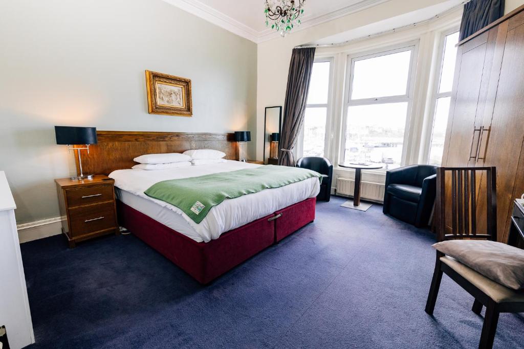 a bedroom with a bed and a large window at The Nines in Bangor