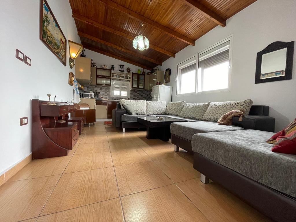 a living room with a couch and a table at Johnny Apartment Berat in Berat