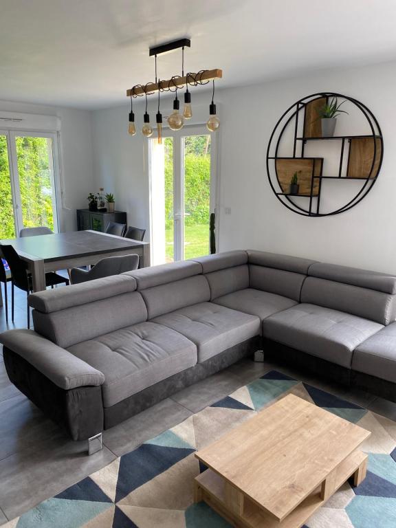 a living room with a couch and a table at Maison pour 4 personnes proche Caen et mer in Saint-Manvieu