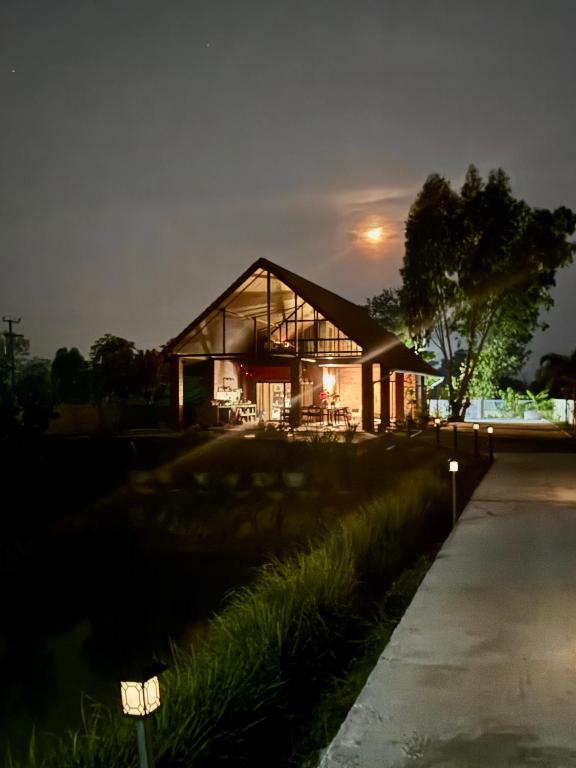 a house at night with the lights on at Mayuree-Homestay in Kranuan
