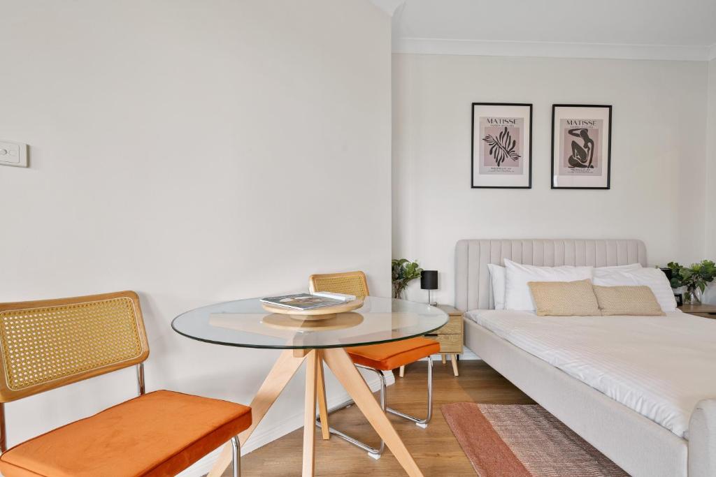 a living room with a table and a bed at Newly Renovated Central Private Studio in Pokolbin