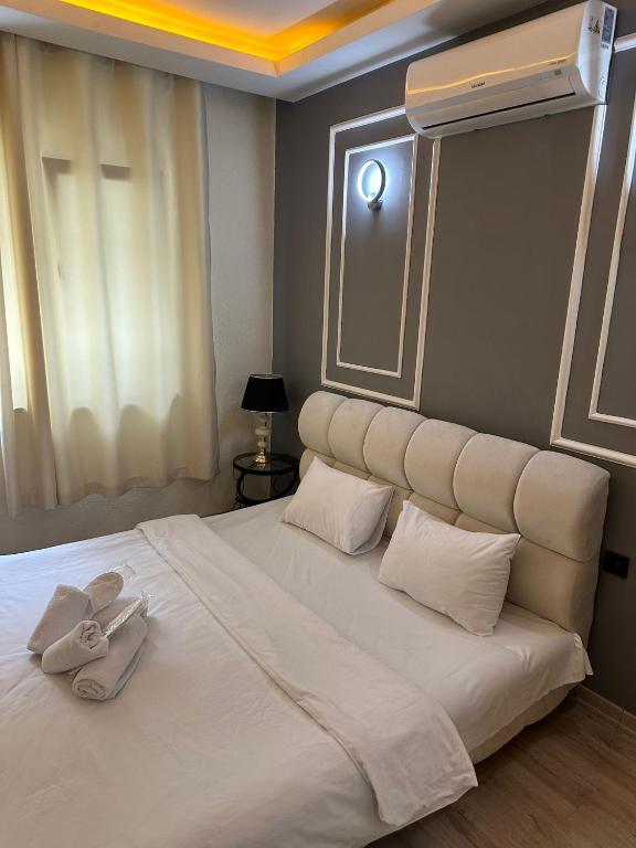 a bedroom with a large white bed with towels on it at Vip Otel in Istanbul