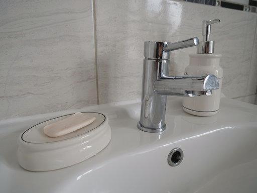 a bathroom sink with a toilet and a faucet at Elsham Gardens Rooms - Shared Facilities in Manchester