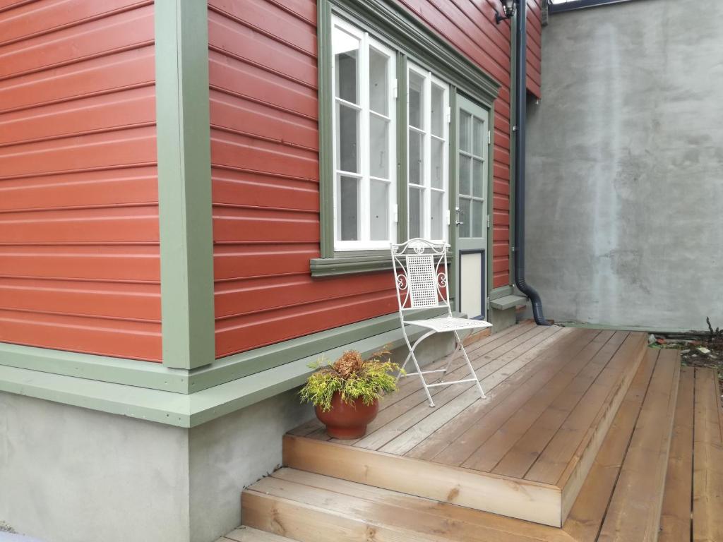 a chair sitting on a deck next to a house at Matrix Garden Apartments in Tallinn