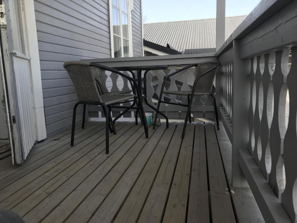 a patio table and chairs on a porch at Lägenhet/Apartment Krylbo, Avesta Sweden in Avesta