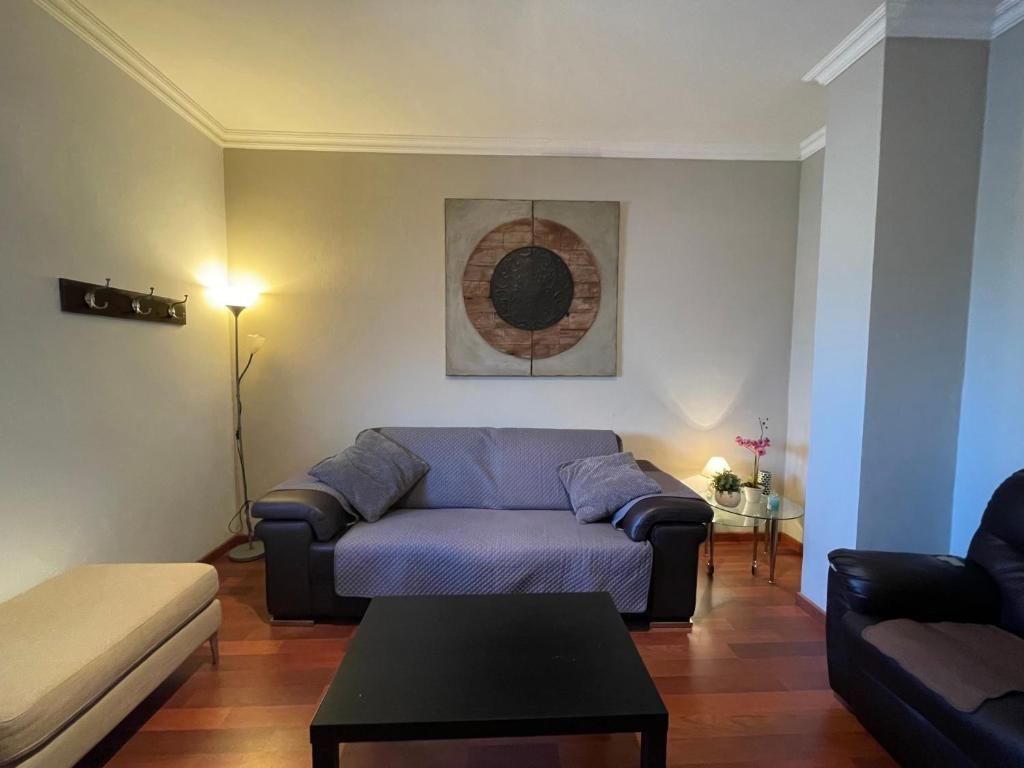 a living room with a couch and a table at Apartamento Puerto Rosario centro in Puerto del Rosario