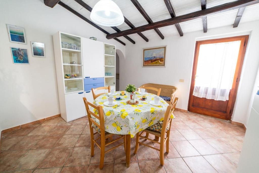 a dining room with a table and chairs at La Cicocca in Portoferraio