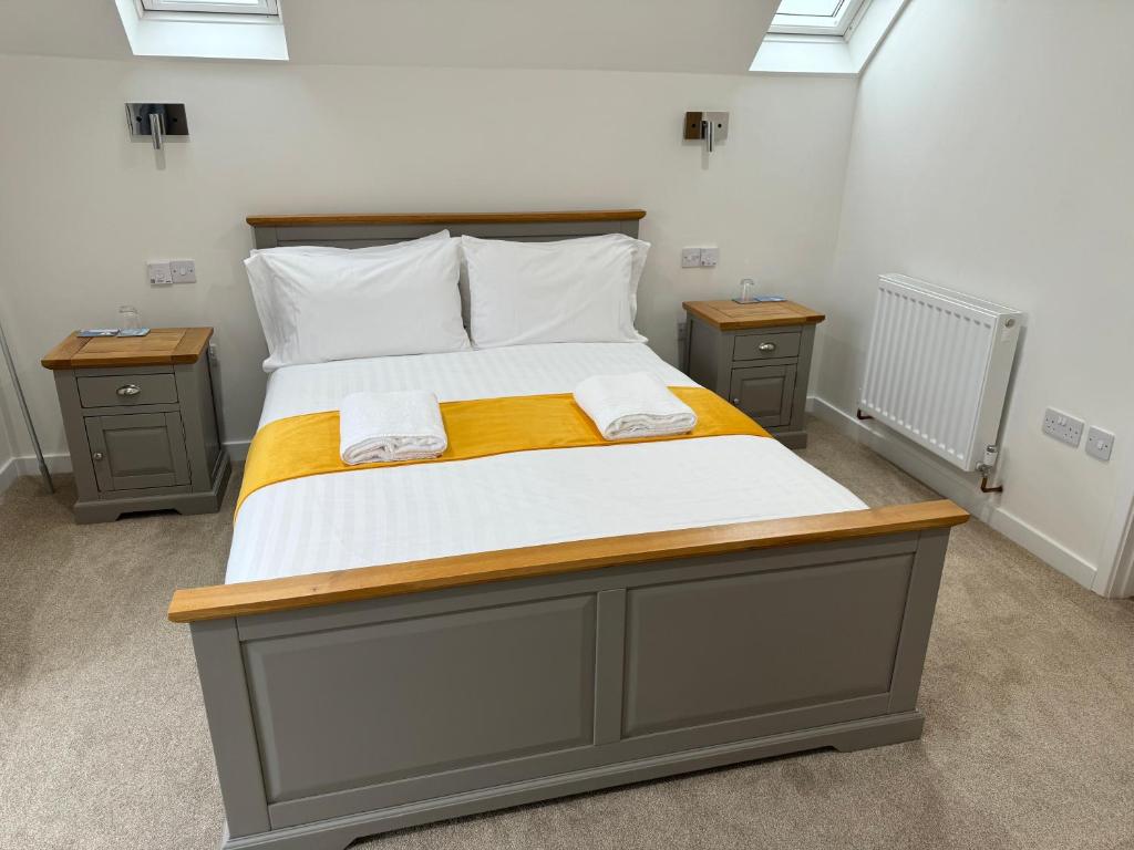 1 dormitorio con 1 cama grande y 2 mesitas de noche en Wayfarers Lodge en Penzance