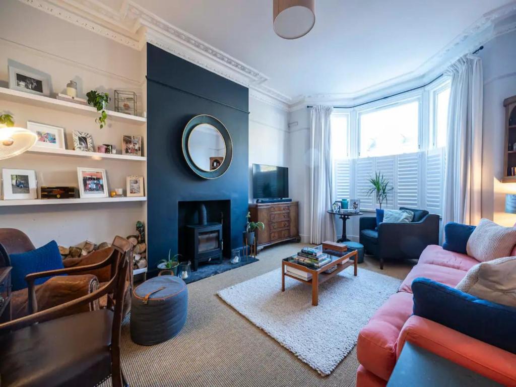 a living room with a couch and a fireplace at Pass the Keys London Spacious Dulwich family house with Pool in London