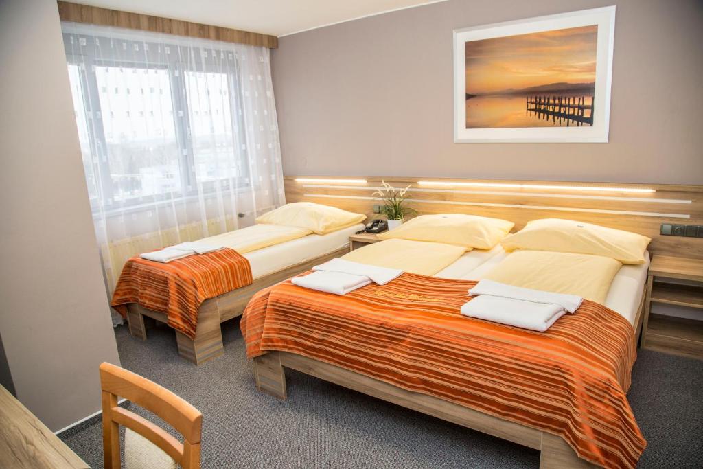 Postel nebo postele na pokoji v ubytování Hotel Panon