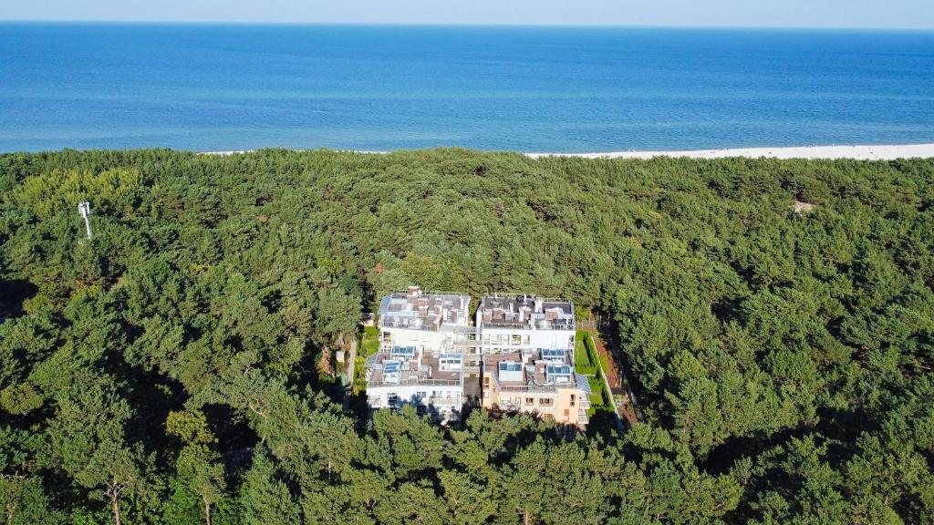 an aerial view of a large house in the forest at Surf&biKe apartments Jurata in Jurata