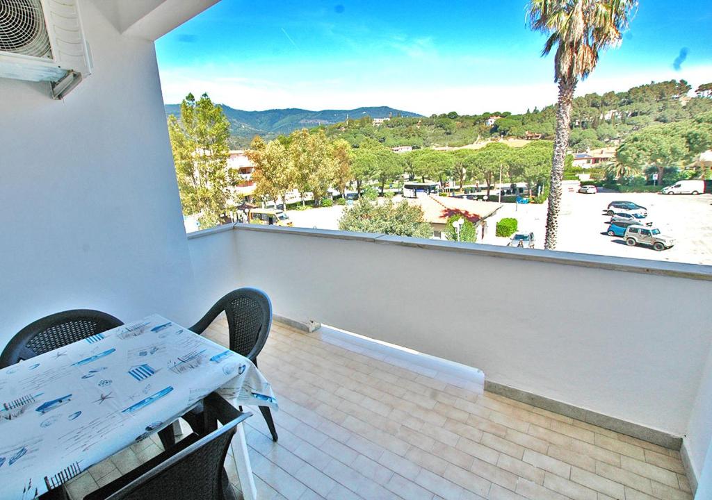 a balcony with a table and a view of a parking lot at Orizzonti in Marina di Campo