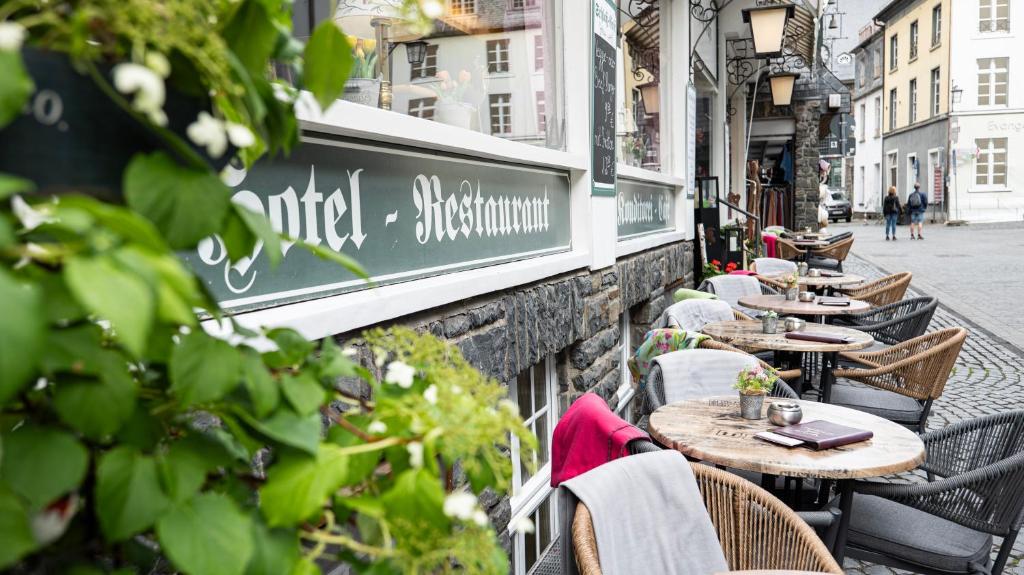 a row of tables and chairs outside of a restaurant at Hotel Royal in Monschau
