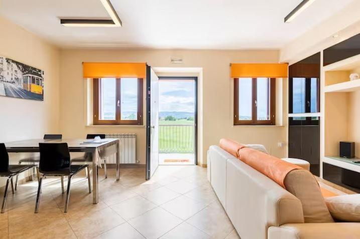 a living room with a white couch and a table at Vacancuore, a casa di Giada in Bastia Umbra