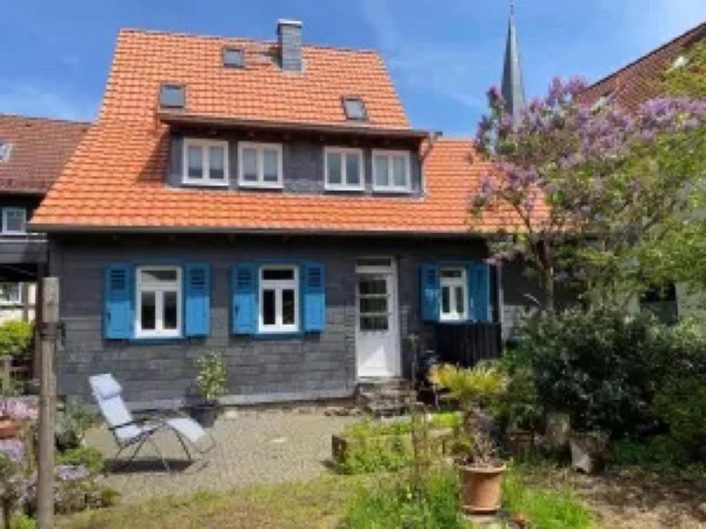 a house with an orange roof and a yard at Ferienhaus Schotten in Schotten
