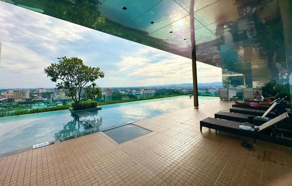 - une vue sur la piscine dans un bâtiment dans l'établissement The Astra one bedroom apartment, à Chiang Mai