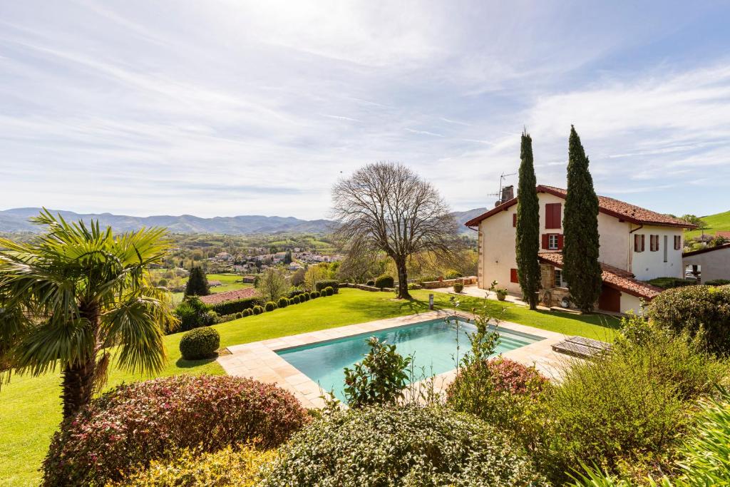 an estate with a swimming pool in a garden at MAISON BASQUE D'EXCEPTION - SARE in Sare