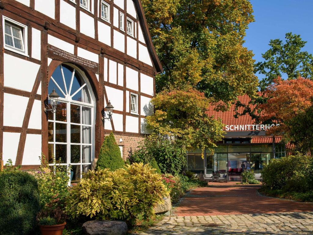 an exterior view of a building with a store at Hotel Schnitterhof in Bad Sassendorf
