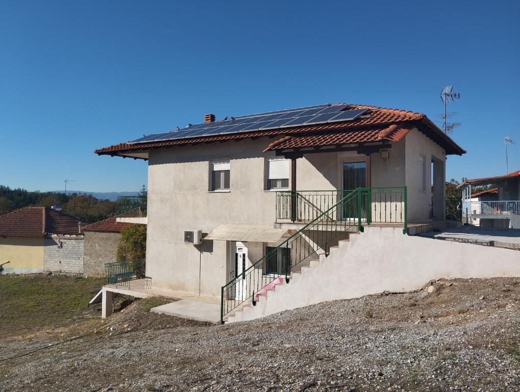 a house with solar panels on the roof at Villa Platania in Palaiokómi