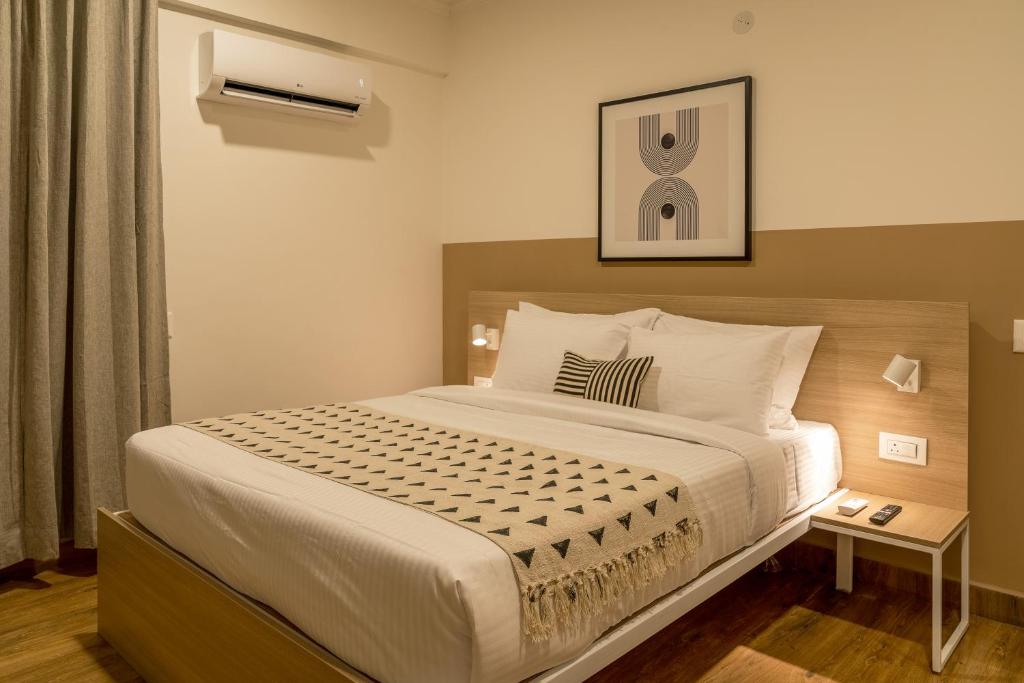 a bedroom with a large bed in a room at Olive Koramangala 4th Block by Embassy Group in Bangalore