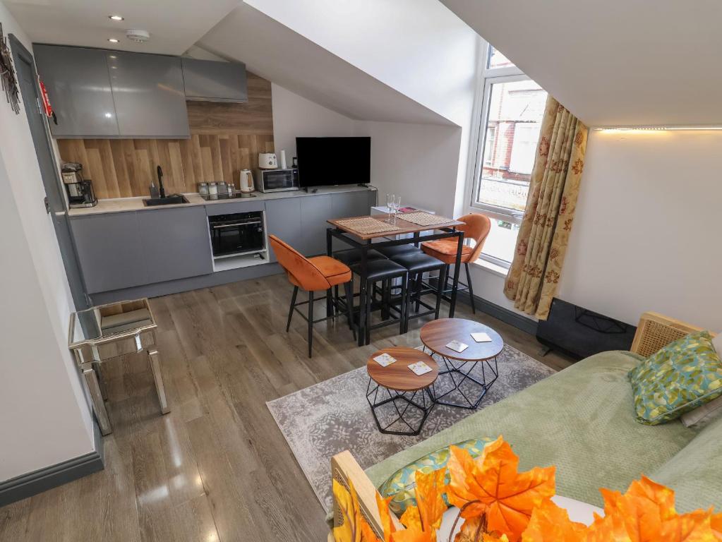 a living room and kitchen with a couch and a table at Apartment 2 in Chester