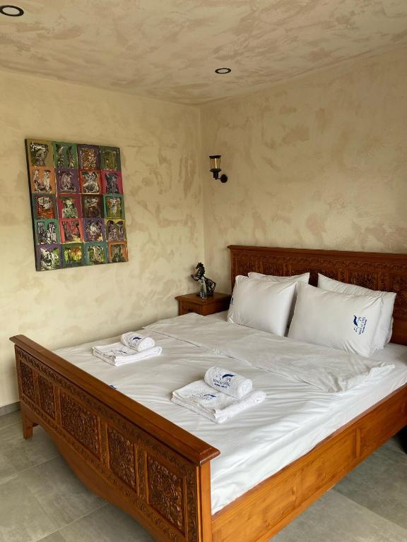 a bedroom with a large bed with two towels on it at MAVİ AT HOTEL Blue Horse in Gümüşdere