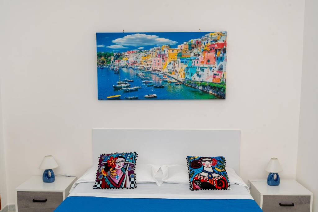 a bedroom with a bed with a painting on the wall at Divina suite Cavaliere in Maiori