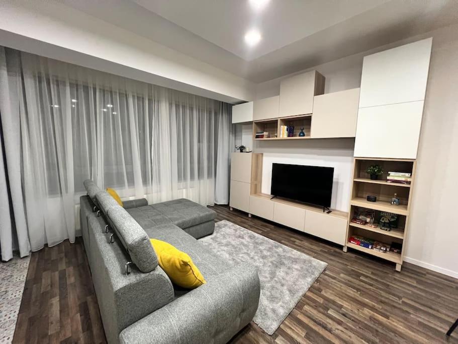 a living room with a couch and a television at Stylish newly renovated apt feels like second home in Bucharest