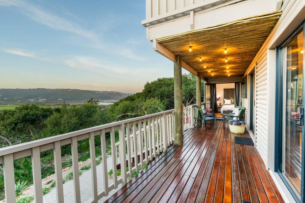 a deck with a view of the ocean at The Milkwoods Luxury Living in Mossel Bay