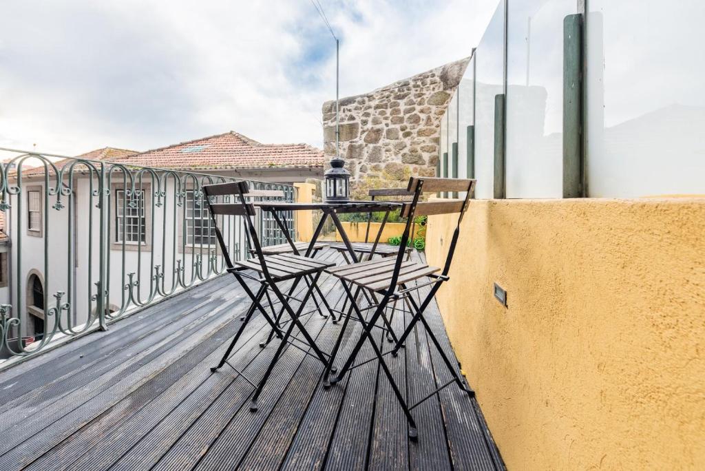 a pair of chairs sitting on a balcony at GuestReady - Flat59 Terrace in Porto