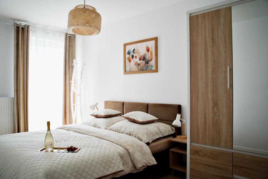 a bedroom with a bed and a window at Magic Apartments - Bulwary 3 in Oświęcim