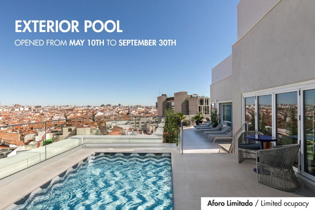 a view from the balcony of a house with a swimming pool at Room Mate Macarena – Gran Vía in Madrid