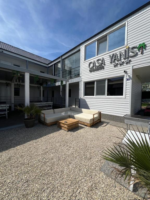 a building with couches sitting outside of it at Vila Yanis Vama Veche in Vama Veche
